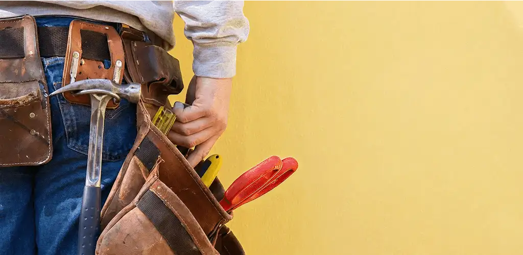 Handyman with tool belt ready for home repairs and maintenance in San Jose, CA