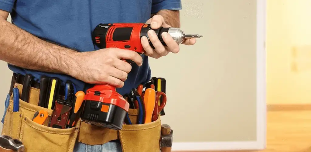 Handyman holding a power drill for home repairs and installations in San Jose, CA
